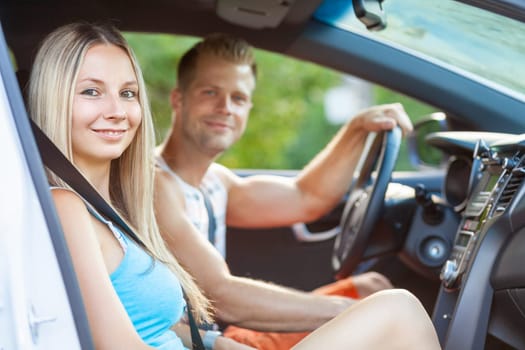 Young happy people enjoying a roadtrip in the car
