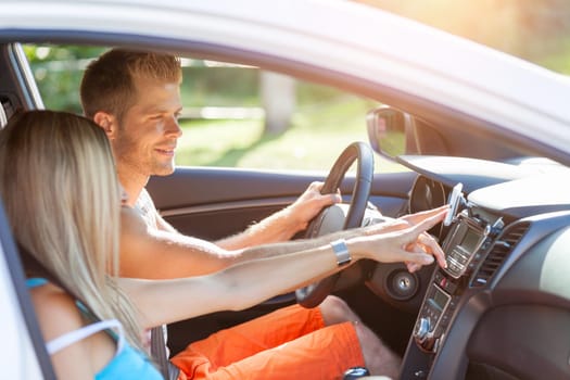 Young happy people enjoying a roadtrip in the car