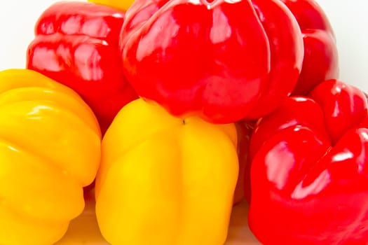 Photo of fresh red and yellow raw pepper on white background