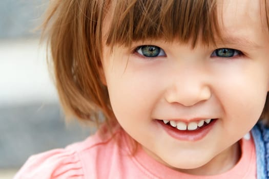 Photo of cute smiling Caucasian girl with short hair