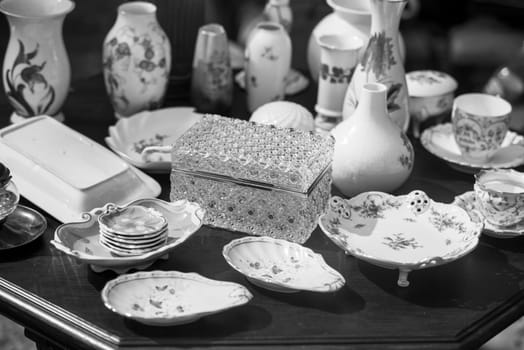 close up on porcelain plates placed on the cement floor