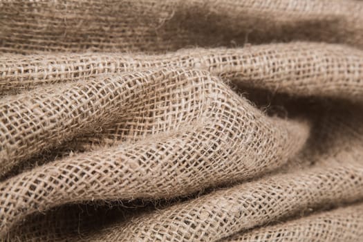 burlap or jute open woven texture background. Shallow DOF