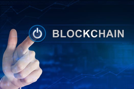 double exposure business hand clicking blockchain button with blurred background