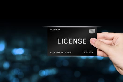hand picking license platinum card on blur background