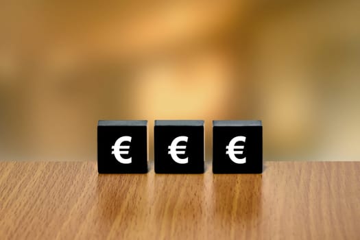 euro currency on black block with blurred background