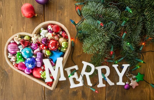 Various colorful Christmas tree balls in one heart shape