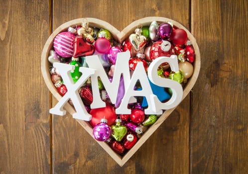 Various colorful Christmas tree balls in one heart shape