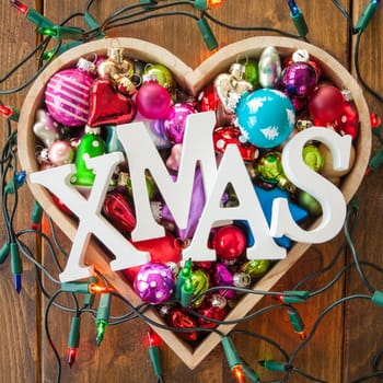 Various colorful Christmas tree balls in one heart shape