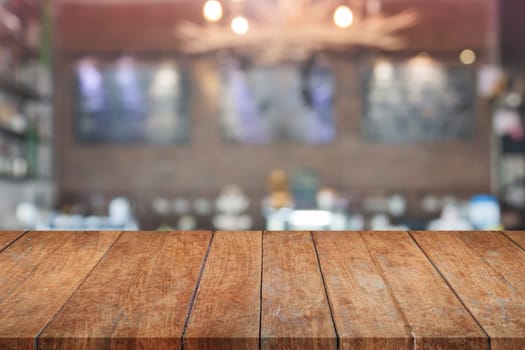 Brown wooden table top with blurred cafe. product display template