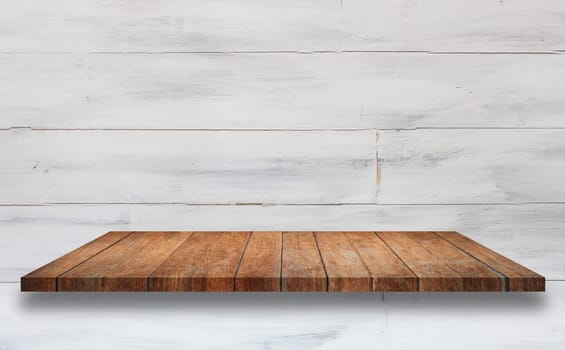 Top of brown wooden shelf with white wooden wall background. For product display