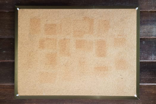 Blank cork board on wooden wall