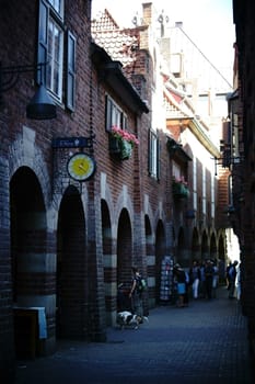 Bremen,Germany - August 30,2016: Pedestrians with dogs walk through the narrow and well-known Böttcher Straße with shops and shops on August 30,2016 in Bremen.
