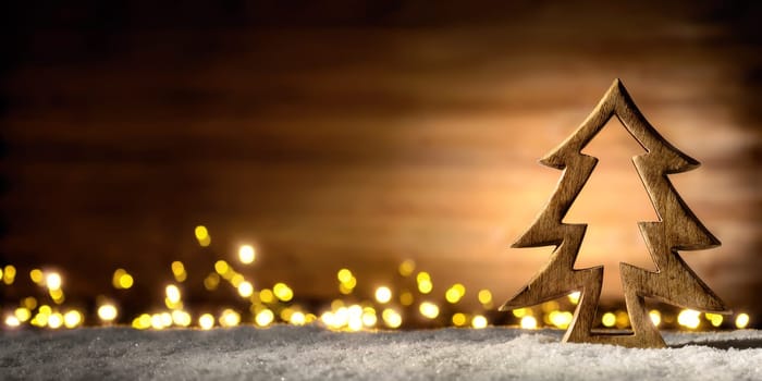 Cozy Christmas arrangement with beautiful wooden ornaments on snow in the warm candlelight of a nice lantern,low-key studio shot
