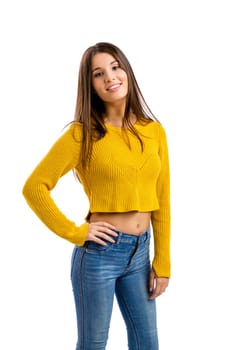 Beautiful and happy teenage girl pointing, isolated over white background