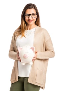 Beautiful and happy woman holding a piggy bank and making thumb up