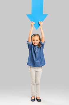 Girl holding a big blue arrow