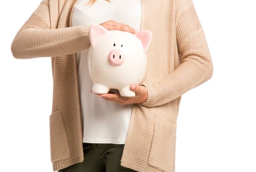 Beautiful and happy woman holding a piggy bank and making thumb up