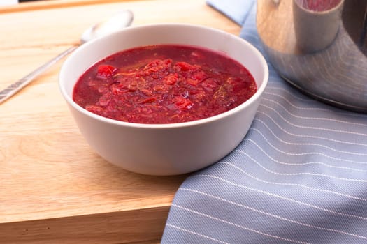 Bowl of homemade borscht on table.