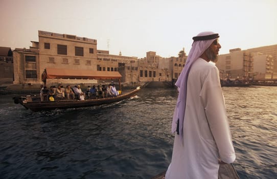 a city boat and ferry on the Dubai creek in the old town in the city of Dubai in the Arab Emirates in the Gulf of Arabia.