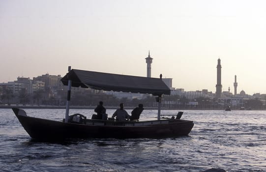a city boat and ferry on the Dubai creek in the old town in the city of Dubai in the Arab Emirates in the Gulf of Arabia.