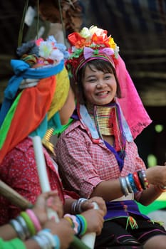 A traditionally dressed long-necked woman of a Paudang tribe from Burma lives in a village of Chiang Mai in northern Thailand