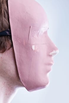 man with mask in a foreground portrait brightly lit