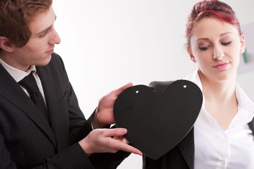 business man loving busines woman and offering a heart