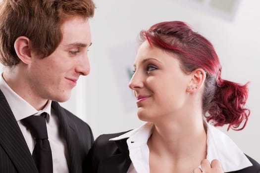 business man and woman looking in their eyes