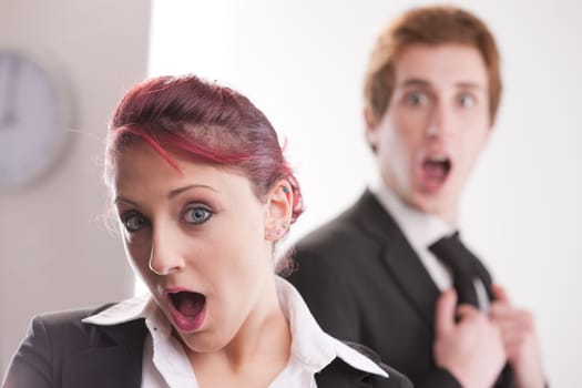 astonished business people in their office
