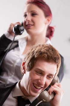 smiling office workers in a call center with phones