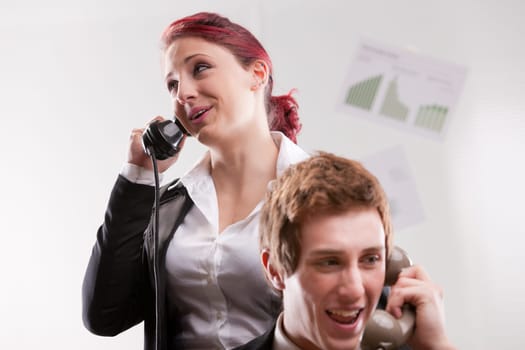 smiling office workers in a call center with phones