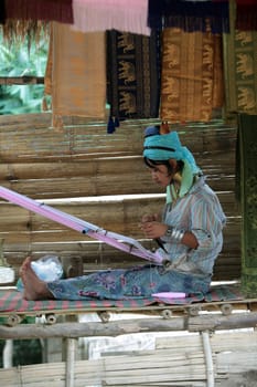 a traditional longneck women of the Paudang minority from Burma in a village north of chiang mai in the north of Thailand in Southeastasia. ...