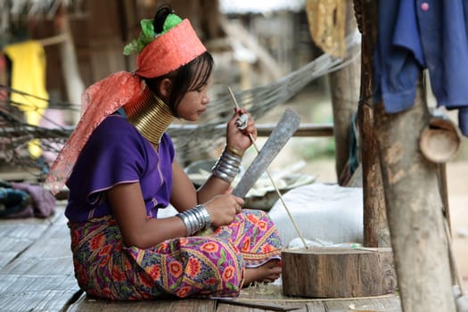 a traditional longneck women of the Paudang minority from Burma in a village north of chiang mai in the north of Thailand in Southeastasia. ...