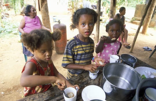 Childin a kitchen at the Village of Las Terrenas on Samanaon in The Dominican Republic in the Caribbean Sea in Latin America.