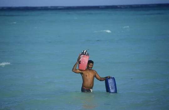 A Fisherman on the way from the Boat to the Village of Las Terrenas on Samanaon in The Dominican Republic in the Caribbean Sea in Latin America.