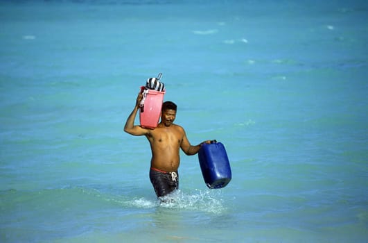 A Fisherman on the way from the Boat to the Village of Las Terrenas on Samanaon in The Dominican Republic in the Caribbean Sea in Latin America.