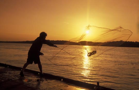 a fishing men at the river Danube in the city of Ruse on the border to romania in Bulgaria in east Europe.