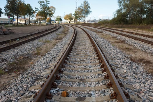 Three trails of rail road tracks near a city