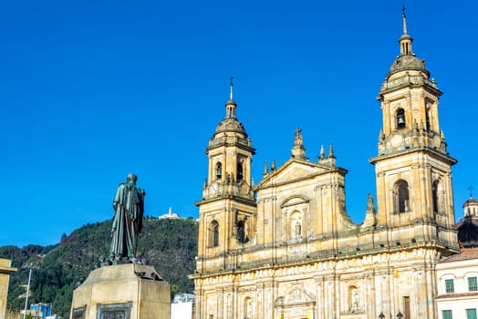 View of the cathedral in the Plaza de Bolivar in the center of Bogota, Colombia with Monserrate visible on the hill in the background