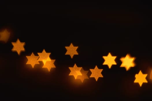 Beautiful bokeh lights in shape of the Star of David for Hanukkah celebration. Jewish Holiday background.