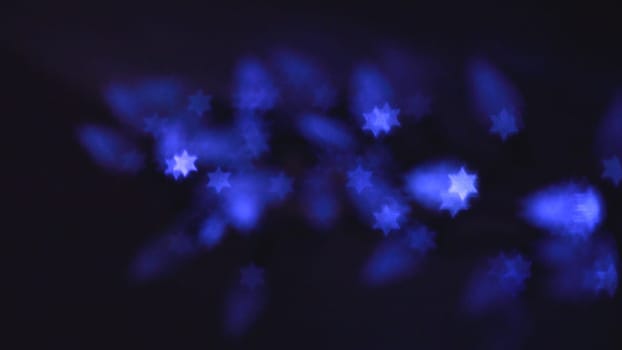 Beautiful bokeh lights in shape of the Star of David for Hanukkah celebration. Jewish Holiday background.