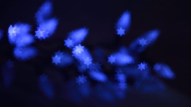 Beautiful bokeh lights in shape of the Star of David for Hanukkah celebration. Jewish Holiday background.