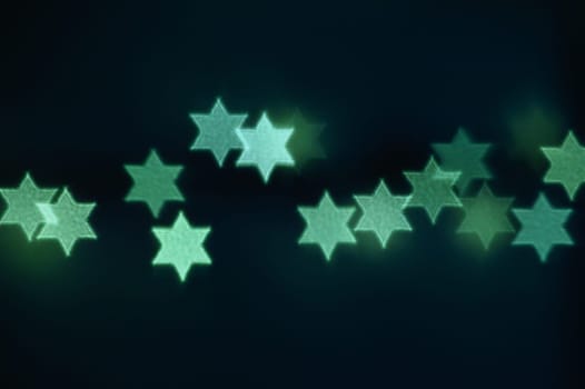 Beautiful bokeh lights in shape of the Star of David for Hanukkah celebration. Jewish Holiday background.