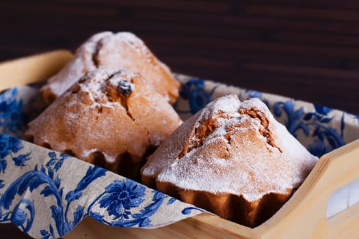 Muffin cakes in wooden tray.  Stock image.