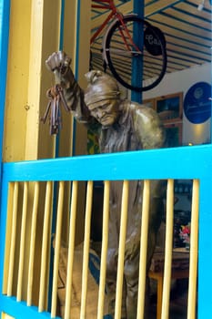 SALENTO, COLOMBIA - JUNE 6: Statue holding keys in a coffee shop in Salento, Colombia on June 6, 2016
