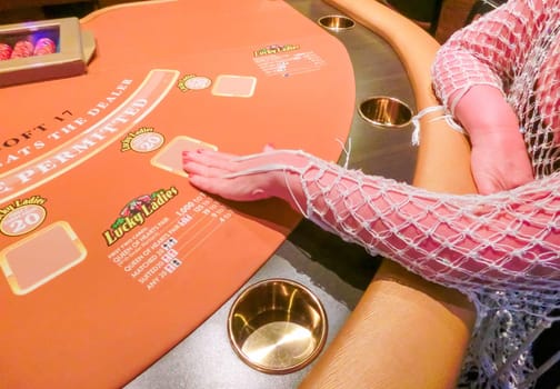 Las Vegas, United States of America - May 11, 2016: The woman sitting at the card game table in the Fremont Casino at Las Vegas, United States of America
