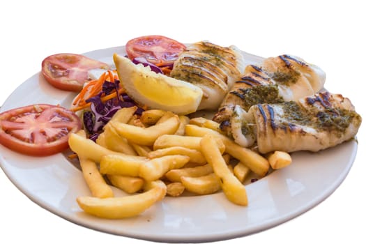 Grilled octopus. Grilled squid served with French fries and lemons and salad.