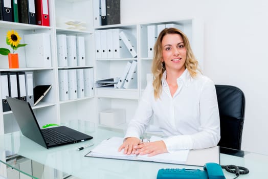young blond businesswoman working in the office