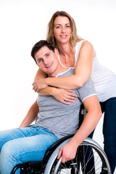 young disabled man in wheelchair and his wife