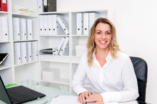young blond businesswoman working in the office